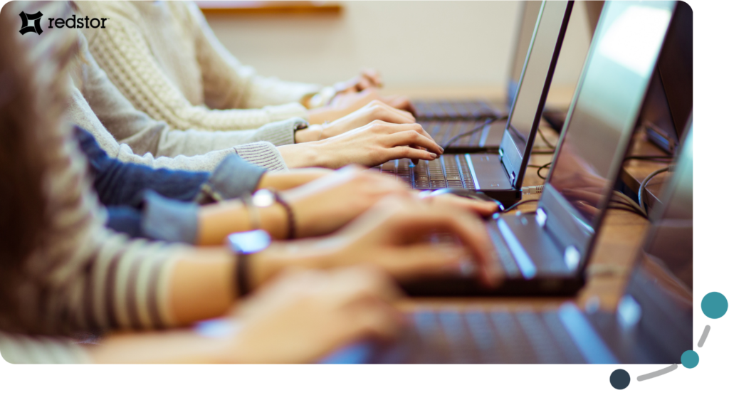 Students typing on their laptops