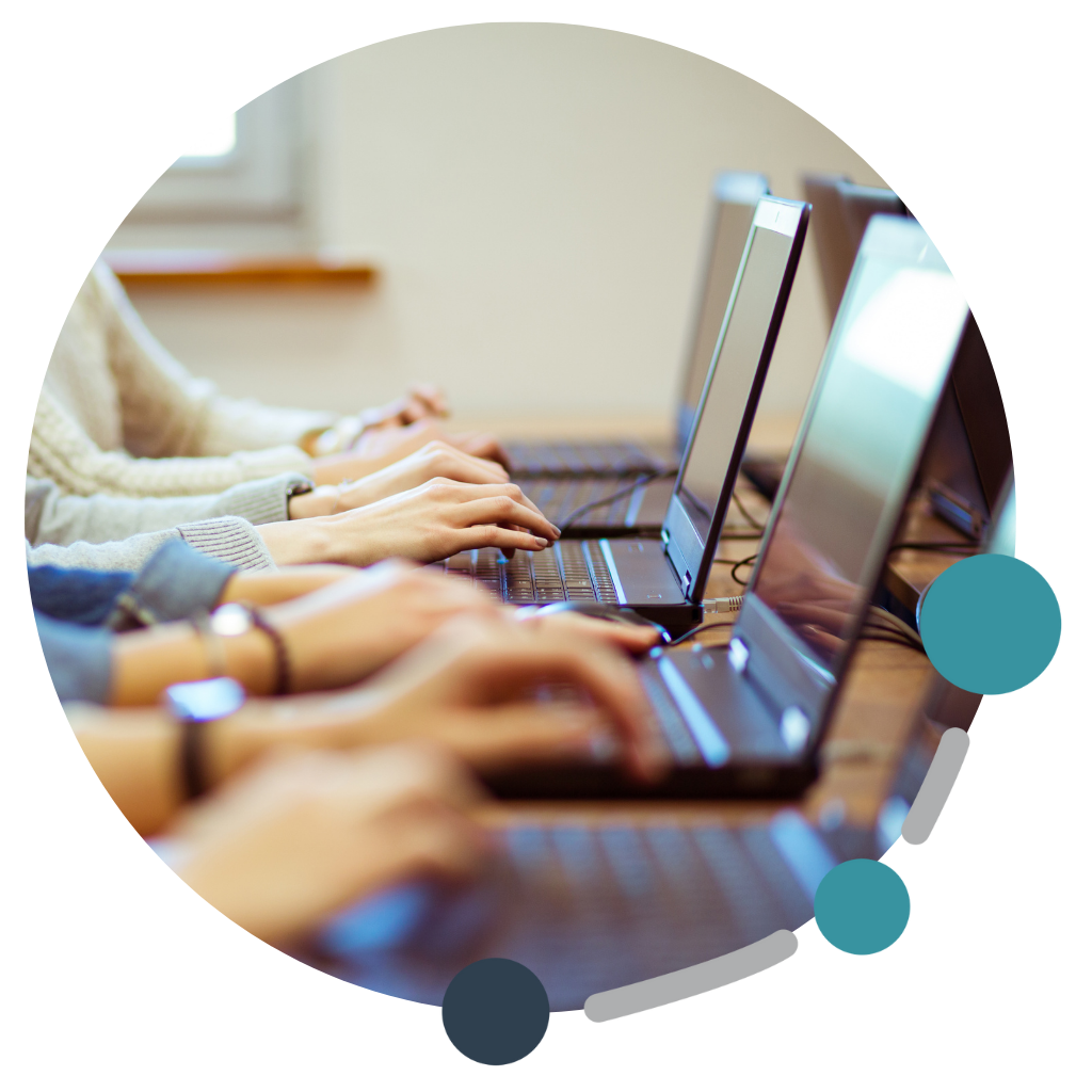 Students typing on their laptops
